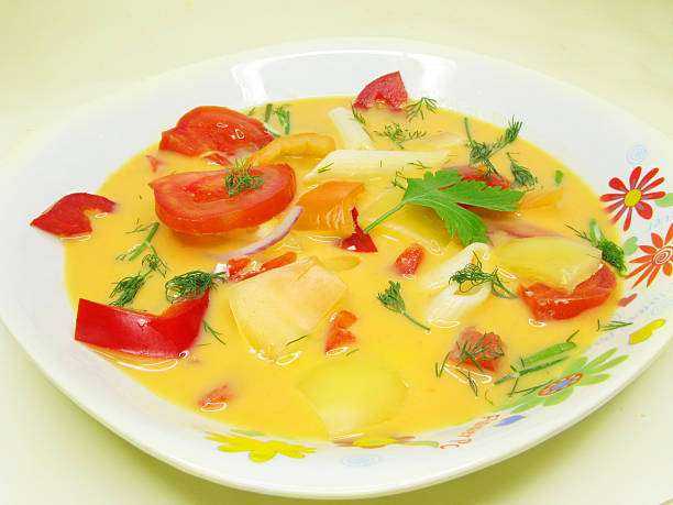 istock yellow vegetable soup with tomato and pasta 174171156