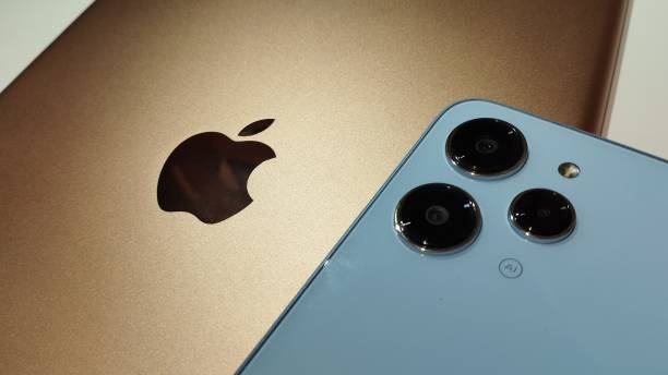 Gold iPad and Xiaomi Redmi 12 Sky Blue color. Close-up. Concept of Confrontation between Apple and Xiaomi. Stock editorial photo. 16.10.2023 Ukraine. Kyiv