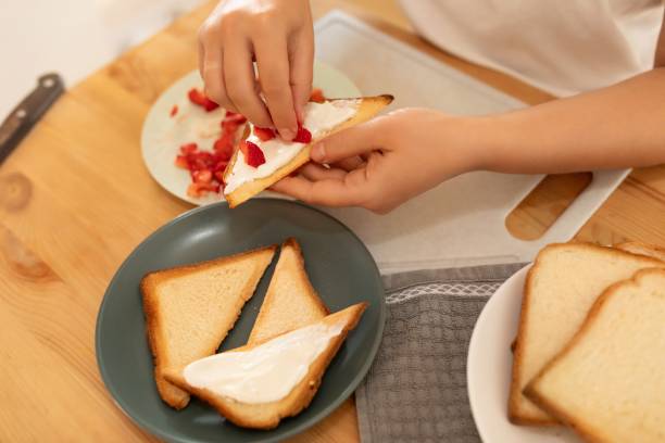 istock a woman makes a sandwich for a snack in the kitchen 1741728705