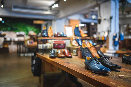 Worn high-heeled women's shoes on display in a shoe repair shop