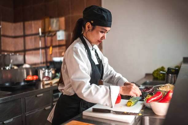 istock Asian Woman Using a Kitchen Knife 1741732598