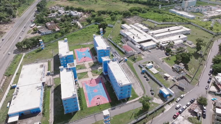 Najayo prison and recreation area with basketball courts, San Cristobal in Dominican Republic. Aerial top-down orbiting