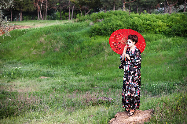 istock Walking geisha with umbrella 174174561