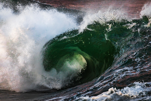 Large powerful wave breaking over shallow reef generated by a storm system off the coast of Australia.