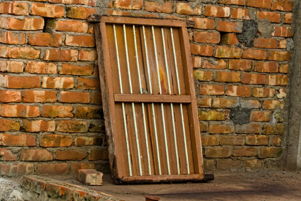 an old wooden frame window kept beside a wall