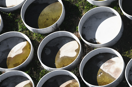 Aerial of concrete pots arranged within an industrial site, revealing efficient organization.
