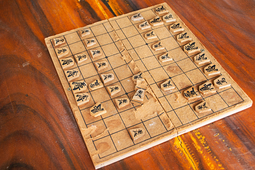 Wood board of japanese chess or Shogi board game on wooden table for thai people player playing competition match at Wat Khao Din Temple at Suphanburi city on October 7, 2023 in Suphan Buri, Thailand
