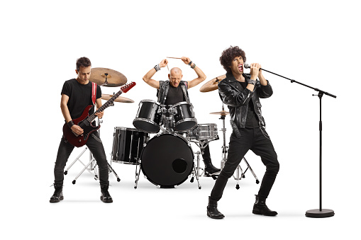 Male music band performing with a guitarist, drummer and a singer isolated on white background
