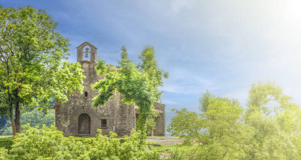 istock Old catholic church with a bell in soft sunlight. Selective focus 1741844124