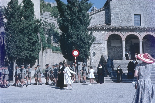 Northern Italy (unfortunately the exact location is not known), 1957. An Italian school class left a church. Also: nuns, teachers and passers-by.