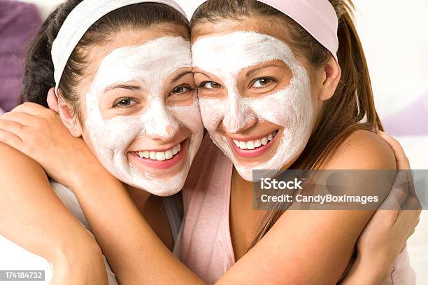 Blissful Girls Applying Mask Hugging Each Other Stock Photo - Download Image Now - Adult, Applying, Beauty Product