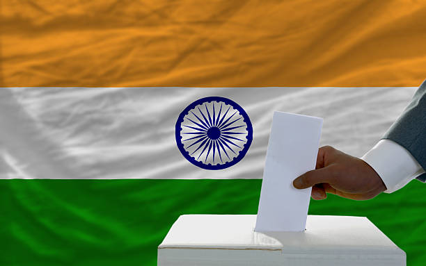 istock man voting on elections in front of national flag india 174186034