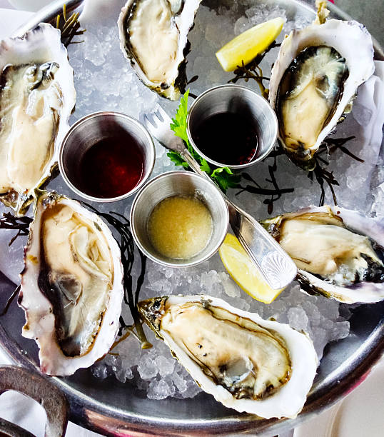 istock Fresh oysters on ice, served with sauces and lemon 174187028