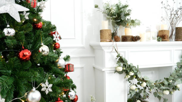 istock Blurred Background Christmas tree decorated holiday winter xmas celebration. Present gift decorate under bauble ornament silver red ball on christmas tree in cozy living room. Blurry background 1741877227