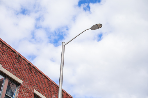 Street lights under the blue sky and white clouds