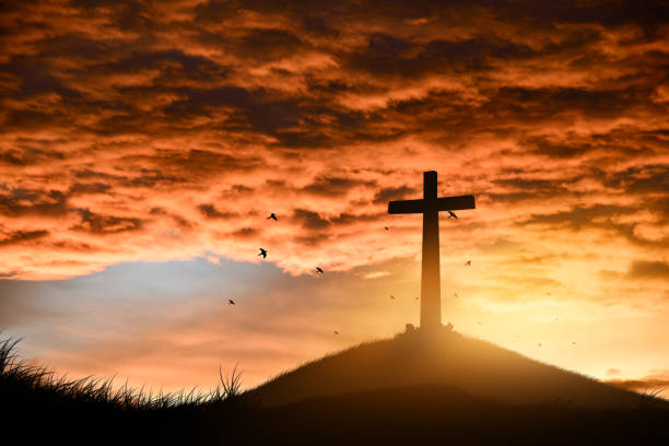 istock Christian, Religion copy space background. cross on blurry sunset background. 1741899073