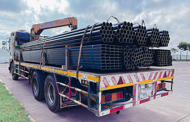 istock Trucks with long trailers carrying steel bars for building construction. Construction steel is ready to be delivered to the customer. 1741902317