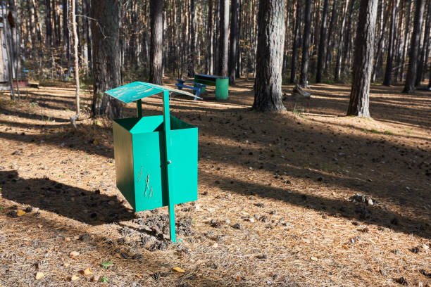istock A green trash can in a pine forest. 1741923088
