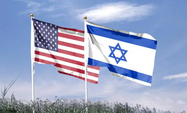 American and Israeli flags fluttered in the cloudy sky. fly in the sky