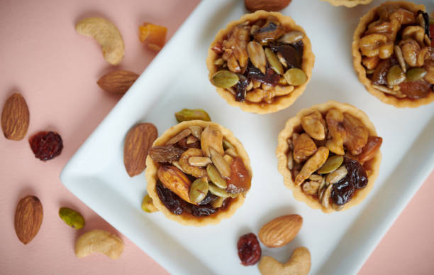 istock Homemade mini tart. Top view with nuts as background. 1741983892