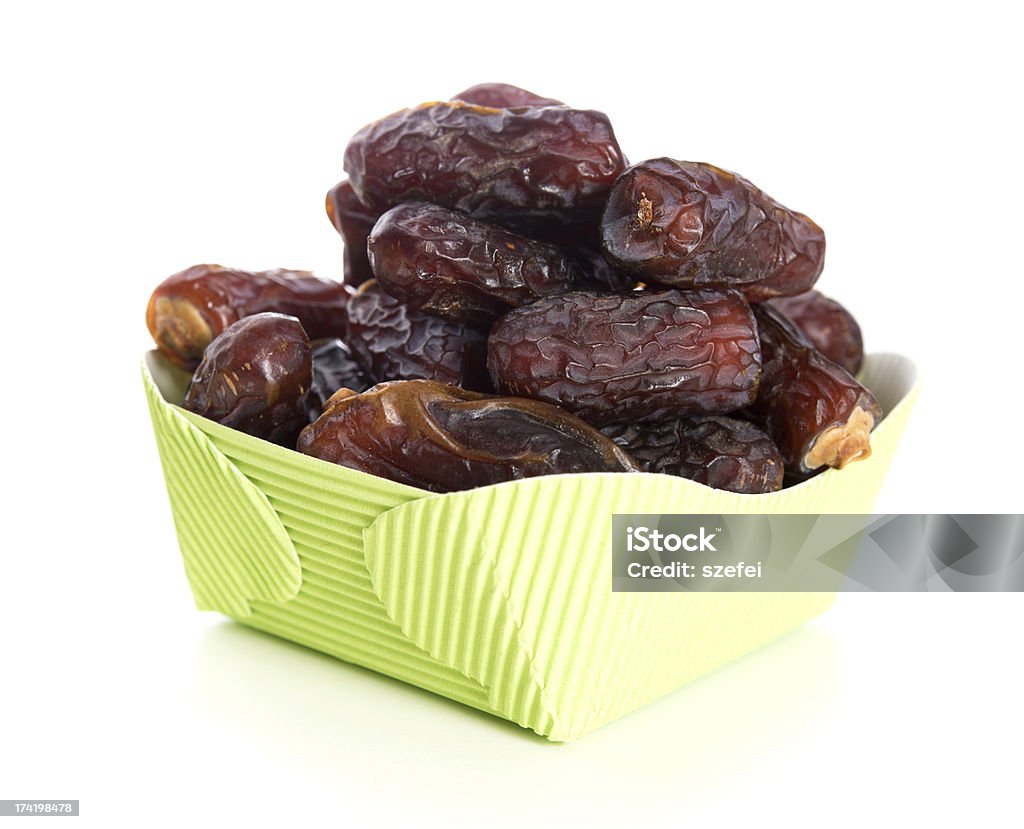 Ramadan food Kurma dried date palm fruits, ramadan food which eaten in fasting month. Pile of fresh dried date fruits in paper box. Arabia Stock Photo