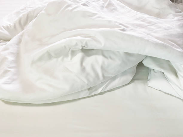 istock Unmade bed; wrinkled pillowcases, bed sheet and duvet 1741997997