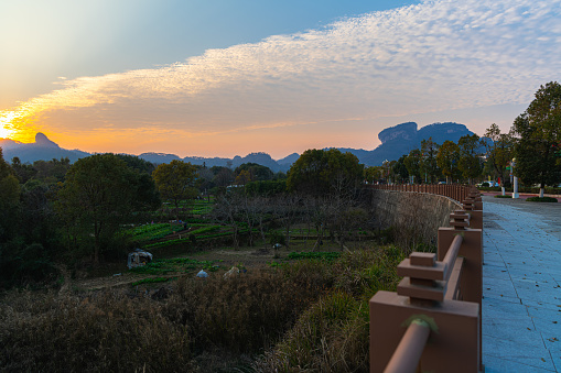 The rural landscape of the garden with vegetables and sun setting behind the mountains in Wuyishan scenic area, Fujian, China