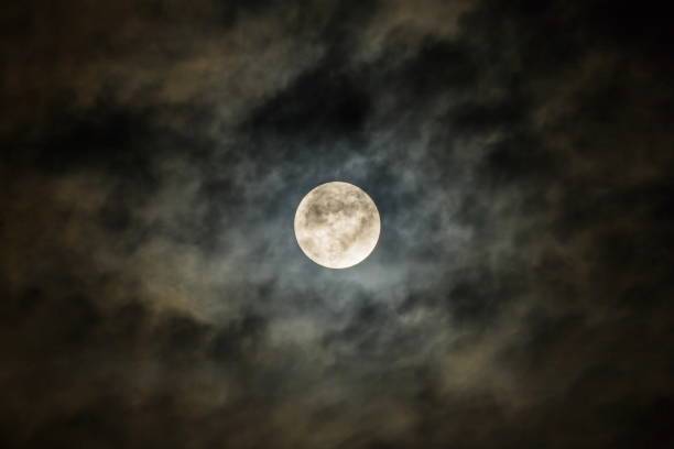 istock Full moon in the dark night sky with clouds. Halloween background,dark clouds, closeup. 1742004450