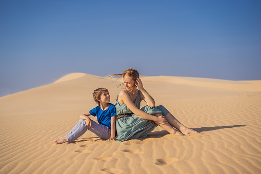 Mother and son in the desert. Traveling with children concept. Tourism reopens after quarantine COVID 19.