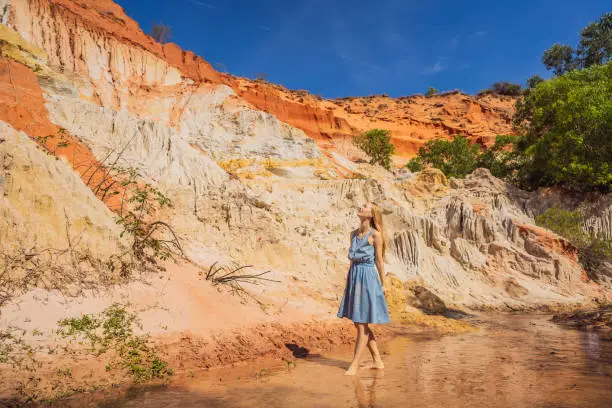 Woman tourist on the Fairy stream among the red dunes, Muine, Vietnam. Vietnam opens borders after quarantine COVID 19.