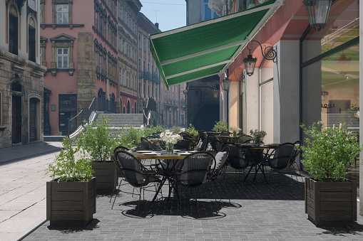 Empty Cafe Exterior With Tables And Chairs On Sidewalk