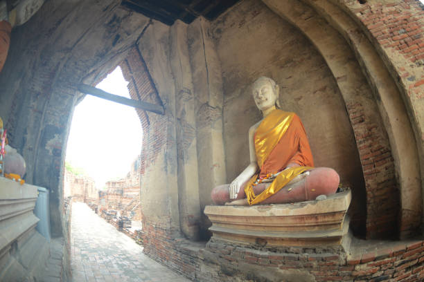 istock An ancient seated Buddha image is placed on the balcony arch. Around Prasat Nakhon Luang, it is approximately 400 years old, which is a tourist and interesting point here. 1742027864