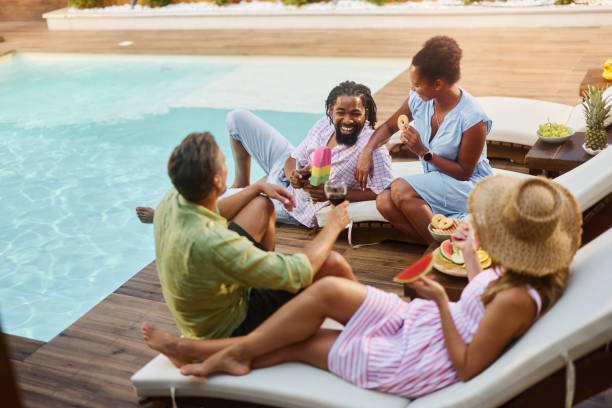 istock Cheerful diverse friends talking during social gathering by the pool. 1742080053