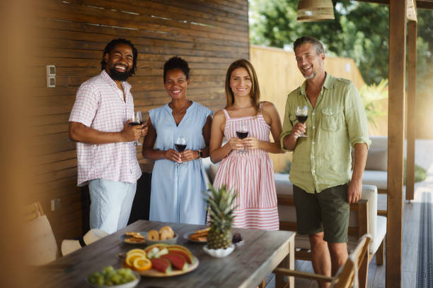 istock Group of happy diverse friends drinking wine on a patio. 1742081103