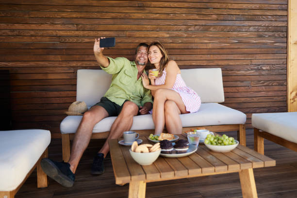 istock Happy couple taking a selfie in summer day on a patio. 1742084849