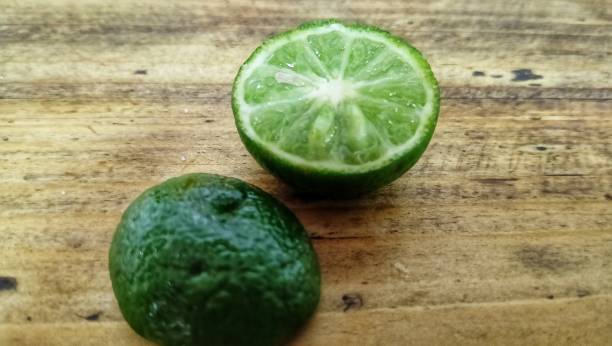istock lime slices on a wooden background. 1742098943