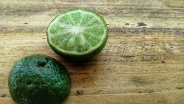 istock lime slices on a wooden background. 1742099462