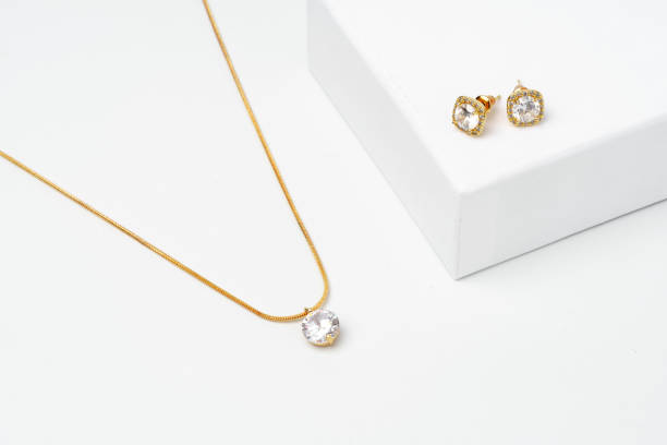 istock Golden diamond neacklace and earrings on white background 1742111822