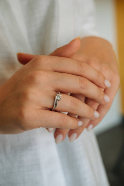 istock Young woman's hand wearing a diamond ring. wedding accessories bride. 1742117974