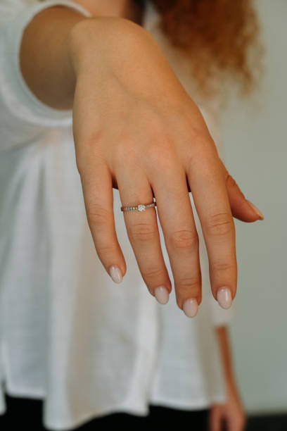 istock Young woman's hand wearing a diamond ring. wedding accessories bride. 1742117977