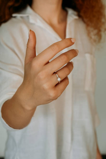 istock Young woman's hand wearing a diamond ring. wedding accessories bride. 1742118013