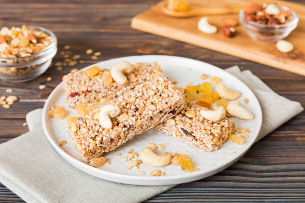 istock Various granola bars on table background. Cereal granola bars. Superfood breakfast bars with oats, nuts and berries, close up. Superfood concept 1742123180