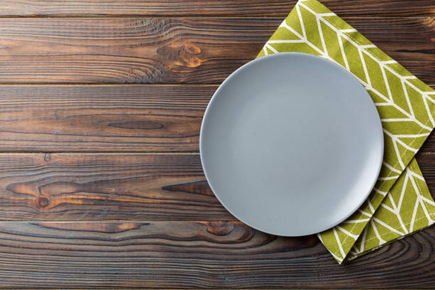 istock Top view on colored background empty round gray plate on tablecloth for food. Empty dish on napkin with space for your design 1742123192