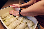 Grandmother making traditional Cabbage Rolls for Christmas