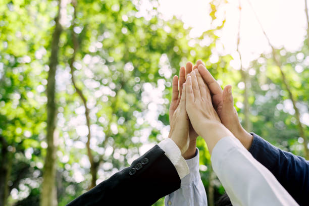 istock Group of volunteer people joining for cooperation about global community teamwork with join hand together, World environment day, sustainable development goal. 1742126717