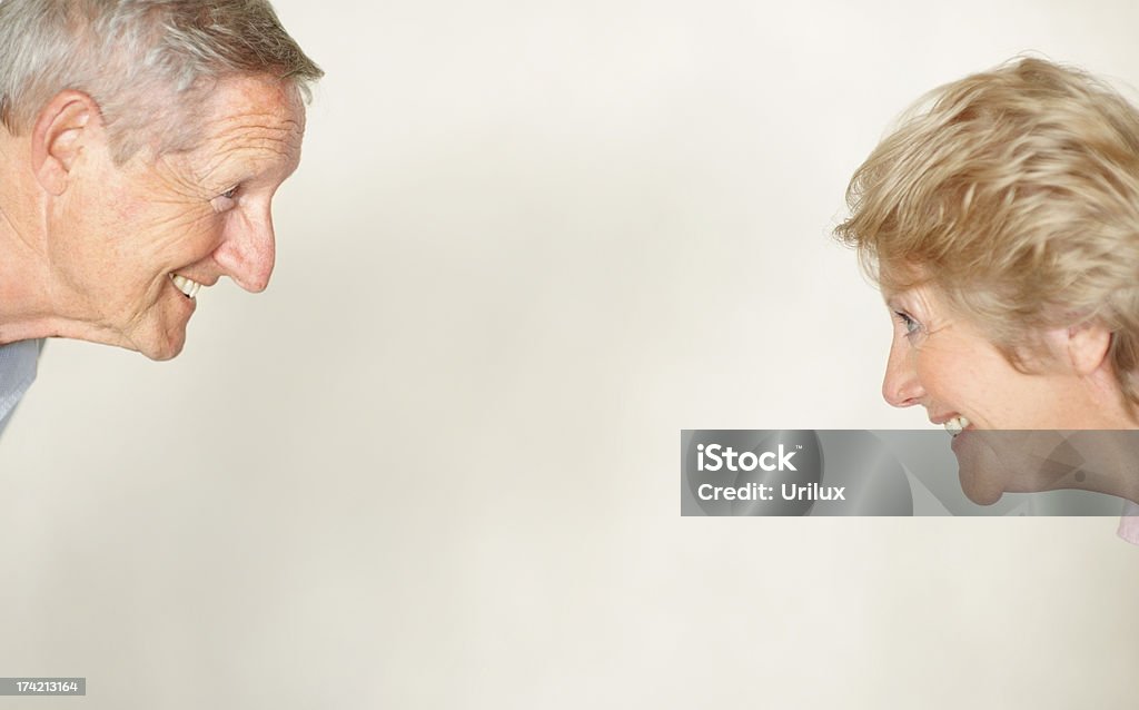 Lovely old couple smiling and looking at eachother  Adult Stock Photo