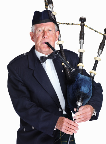 New Delhi, India - January 10, 2010: Scottish piper from Scotland in traditional outfit with tartan kilt playing bagpipe
