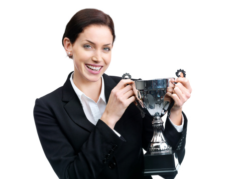 Winning businesswoman with trophy.