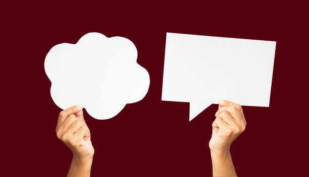 istock Close-up of hands holding a white speech bubbles against a red background 1742152995