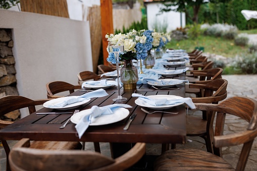 Dinning table decorated for garden party without people during daytime